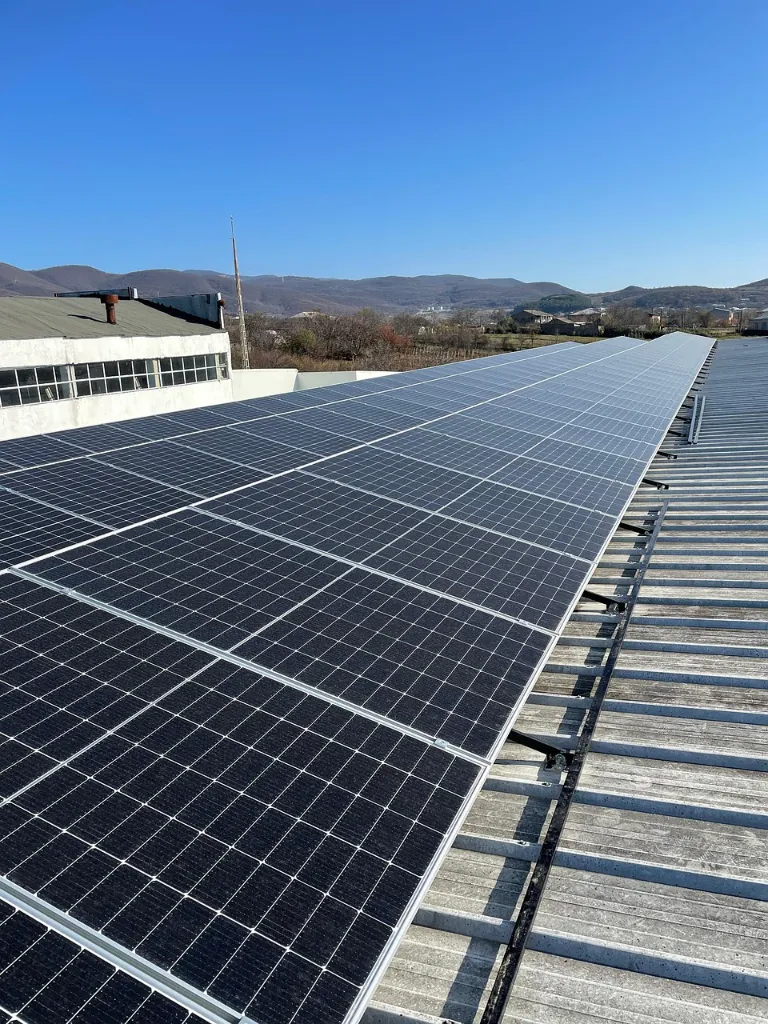 Solar panels on a rooftop with a scenic mountain background
